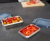 A person is preparing food in a kitchen, with several food storage containers on the counter. Produktbild-Vorschau