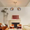 A living room scene with a fireplace, seating, and a ceiling lamp. Produktbild-Vorschau