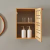 A wooden cabinet with two shelves, containing two glasses on the top shelf and two soap dispensers on the bottom shelf. The cabinet door is open. Podgląd zdjęcia produktu