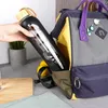 A hand is placing a black water bottle into a backpack. Voir les images du produit