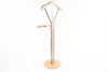 A freestanding valet stand with a wooden base and frame, and metal supports. Anteprima dell’immagine prodotto