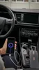 A person is charging a smartphone and a power bank in a car. Náhled obrázku produktu