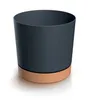A dark gray cylindrical pot with a brown base sits on a white surface. Náhled obrázku produktu