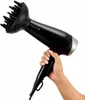A hand holding a black Remington hair dryer with a diffuser attachment. Náhled obrázku produktu