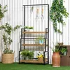 A garden shelf with plants and gardening tools displayed against a white wooden fence. Produktbild-Vorschau