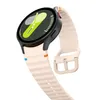 A close-up, angled view of a smartwatch with a pink silicone band. Náhled obrázku produktu