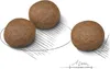 Three pieces of brown kibble are shown on a white background with sketch lines and a ruler indicating 1cm. Náhľad obrázku produktu