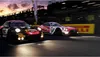 Two racing cars on a track at dusk. Produktbild-Vorschau
