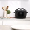 A black Instant Pot multi-cooker is displayed on a kitchen counter, with kitchen utensils and a plant in the background. Anteprima dell’immagine prodotto