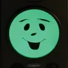 A close-up of a device with a green LED screen displaying a smiley face. Voir les images du produit