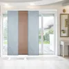 Panel curtains covering a sliding glass door, with a view of a backyard through the glass. Anteprima dell’immagine prodotto