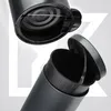 Close-up view of a black trash can with its lid open, showing the inner mechanism and a removable inner bin. Podgląd zdjęcia produktu