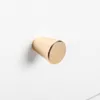 A close-up shot of a single gold-colored drawer knob attached to a white surface. Náhľad obrázku produktu