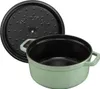 A sage green Staub cast iron pot with its black lid placed next to it, on a white background. Produktbild-Vorschau