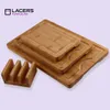 A set of three bamboo cutting boards of different sizes stacked on top of each other, with a wooden holder for them to the left. Produktbild-Vorschau