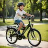 A young boy riding a bicycle in a park. Produktbild-Vorschau