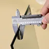 A close-up of a caliper measuring the thickness of a black object. Produktbild-Vorschau