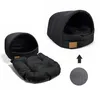 A black dog bed shown in two configurations: assembled and disassembled with the cushion removed. An arrow and a circular texture pattern are also visible. Podgląd zdjęcia produktu