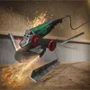 An angle grinder is shown in use, cutting metal, with sparks flying. Two pieces of metal angle stock are also visible. Produktbild-Vorschau