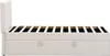 A side view of a beige upholstered bed frame with a slatted mattress support and storage drawers. Produktbild-Vorschau