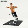 A man is performing a hyperextension exercise on a white fitness machine against a white background. Produktbild-Vorschau