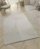 A modern living room with a rug, sofa, and chair. Produktbild-Vorschau