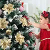 A young girl decorates a Christmas tree with ornaments. Produktbild-Vorschau