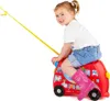 A young girl is riding on a red toy bus with a yellow pull-string, wearing pink rain boots. Produktbild-Vorschau