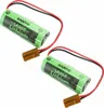 Two green batteries with black and red wires and brown connectors are shown against a white background. Náhled obrázku produktu