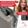 A woman is smiling and holding a phone, with a suitcase in the foreground. The suitcase has a phone plugged into it, showing it is charging. Produktbild-Vorschau