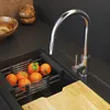 A kitchen sink area with a faucet, a drying rack with oranges, and a cutting board. Produktbild-Vorschau