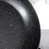 A close-up view of the speckled interior of a black frying pan. Anteprima dell’immagine prodotto