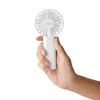 A hand holding a white portable fan. Produktbild-Vorschau