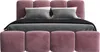A pink upholstered bed with gray and white pillows and a black blanket. Produktbild-Vorschau