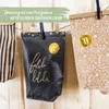 Three paper bags hanging on a string against a wooden background. The bags are decorated with patterns and numbers, suggesting they are part of an advent calendar. Náhľad obrázku produktu