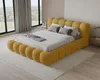 A bedroom scene with a yellow upholstered bed. Voir les images du produit