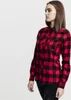 A woman is shown from the side wearing a red and black checkered flannel shirt. Náhled obrázku produktu