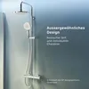 A modern shower system with a rain shower head and a handheld shower head, mounted on a wall against a gradient blue background. Produktbild-Vorschau