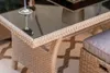 A close-up view of a wicker outdoor furniture set, showing the texture of the material and the glass tabletop. Náhľad obrázku produktu