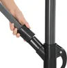 A hand is shown adjusting a part of a dark gray umbrella pole. Voir les images du produit