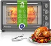 A TurboTronic oven with two chickens roasting inside, and a cooked chicken on a plate in the foreground. Produktbild-Vorschau