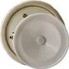 A close-up view of the bottom of a decorative item, showing a screw and a white plastic cover. Náhľad obrázku produktu