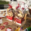 Christmas cookies in packaging bags on a wooden table, with baking ingredients and tools in the background. Produktbild-Vorschau