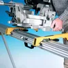 A person is attaching a miter saw to a stand. Produktbild-Vorschau