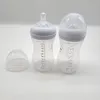 Two baby bottles and a cap are arranged on a white background. Produktbild-Vorschau
