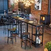 A modern kitchen/dining area with a bar table and stools, a wood-burning stove, and a chandelier. Podgląd zdjęcia produktu