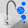 A modern kitchen faucet with a flexible gray hose is shown on a white surface, with blue circles and sparkle icons in the background. Produktbild-Vorschau