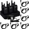 A set of six black walkie-talkies are neatly arranged on a black charging base, with a power adapter and several headsets also visible. Produktbild-Vorschau