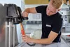 A technician is working on electrical equipment in a workshop. Náhľad obrázku produktu