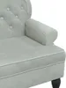 A close-up view of the armrest and seat of a light gray velvet sofa. Náhled obrázku produktu